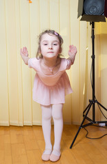 Little girl practicing ballet in a dance studio