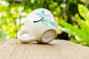coffee cup on wooden board with blur background