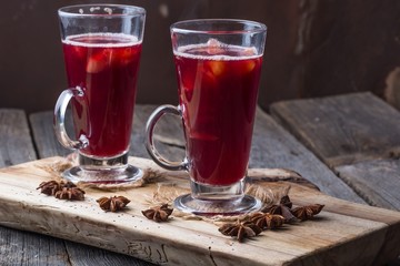 Mulled wine on wooden board and ancient table