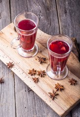 Mulled wine on wooden board and ancient table