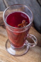 Mulled wine on wooden board and ancient table