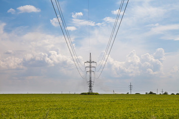 Pillar aerial electrical lines in the green field