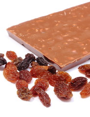 Raisins and whole chocolate on white background