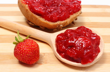 Fresh fruits and strawberry jam on wooden cutting board