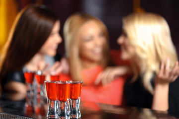 Three women have a drink in the bar