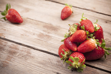 Strawberries on aged wooden background