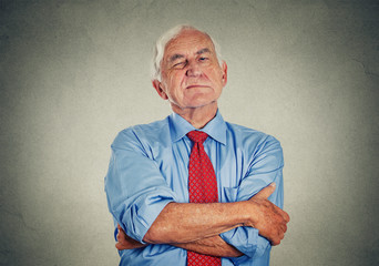 Angry grumpy pissed off senior mature man gray background 