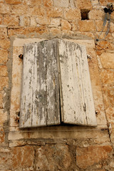 Old rustic window on a traditional mediterranean house.