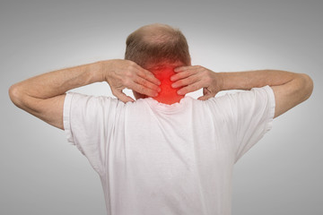 Old man with neck spasm pain touching red inflamed area