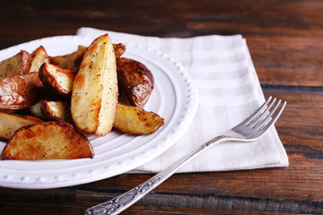 Baked potatoes on pate on wooden table