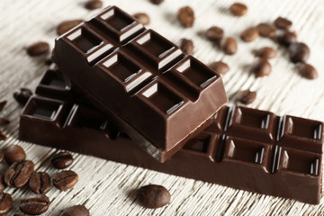 Stuffed chocolate with coffee beans on wooden table, closeup