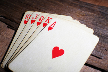 Playing cards on wooden table, closeup