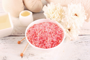 Spa still life with color sea salt on wooden table, closeup