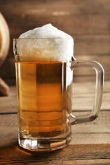 Glass of beer on wooden background