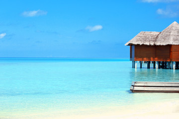 View of beautiful blue ocean water and bungalows in Baros