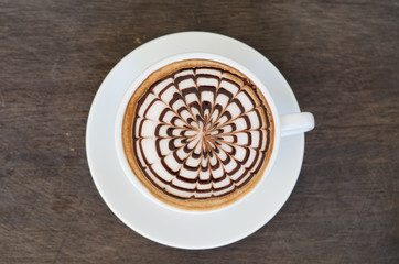 latte art coffee on wooden background