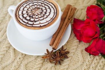 A cup of latte art on a knitted  background