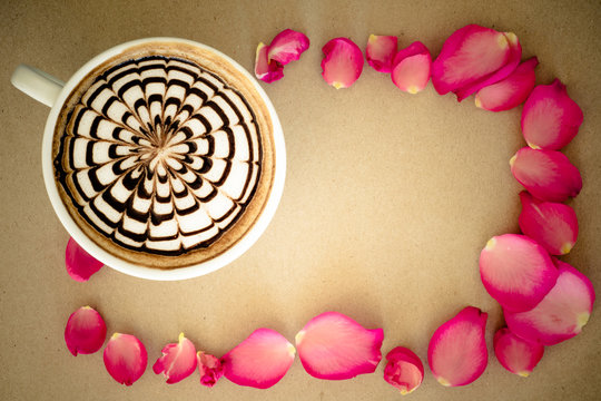 latte art and petals rose on brown paper background
