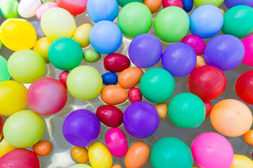 colorful plastic ball floating on water in the pool
