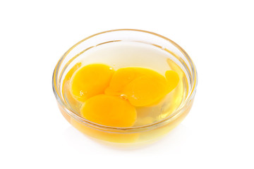 Fresh egg yolks in a glass bowl isolated on white background