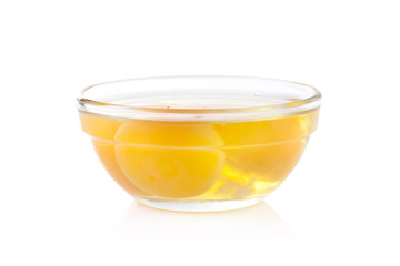 Fresh egg yolks in a glass bowl isolated on white background
