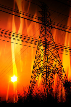 High voltage pole with a flame burning sunset