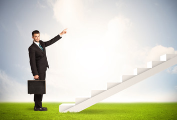 Business person climbing up on white staircase in nature