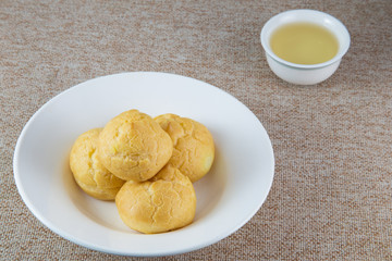eclairs on white dish and tea