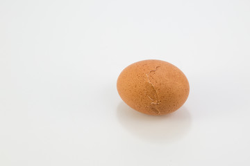 Cracked breakfast egg on white background