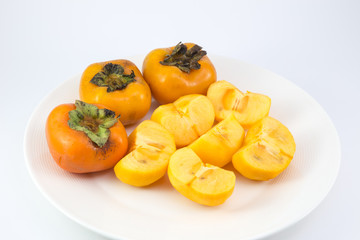 Fototapeta na wymiar persimmon fruit on white dish