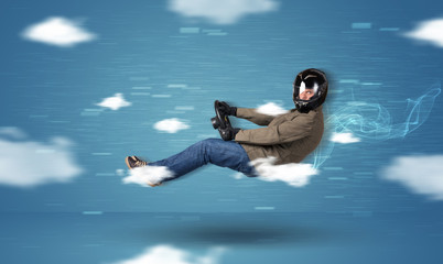 Funny racedriver young man driving between clouds concept