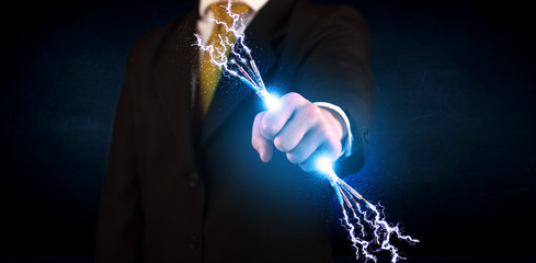 Business person holding electrical powered wires