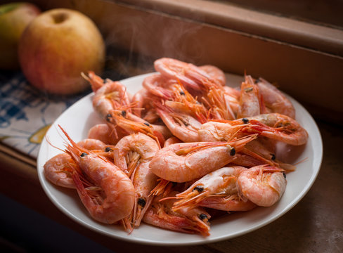Cooked shrimps on white plate. Shallow depth of field.