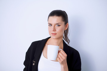 Young woman holding a mug, isolated on white background