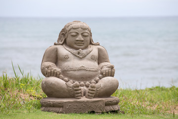 Traditional stone sculpture on the beach in Bali, Indonesia