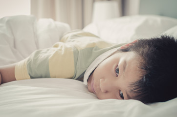 Obraz na płótnie Canvas Close up Asain boy relaxing on bed.