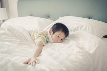 Obraz na płótnie Canvas Close up Asain boy relaxing on bed.