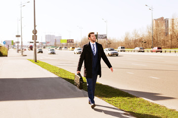 businessman walking along the road