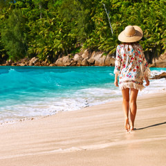 Woman with sarong on beach at Seychelles