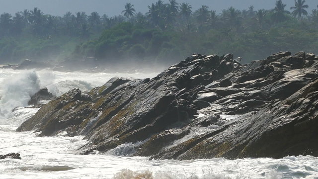 big waves crashing on stone beach - slow motion