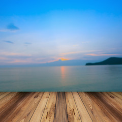 Fototapeta na wymiar wood and blur sea and sunset