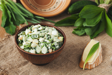 Ramson salad in rustic style with eggs and sandwich