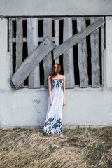 Red-haired pretty young lady in floral dress