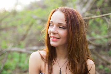 Spring portrait of a smiling red-haired young lady