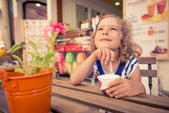 Happy child eating ice-cream