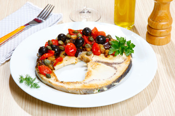 Swordish with tomatoes, capers and olives, sicilian recipe