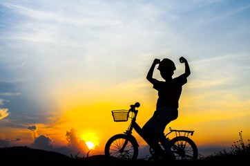 Fototapeta premium Silhouette of the cyclist riding a road bike at sunset