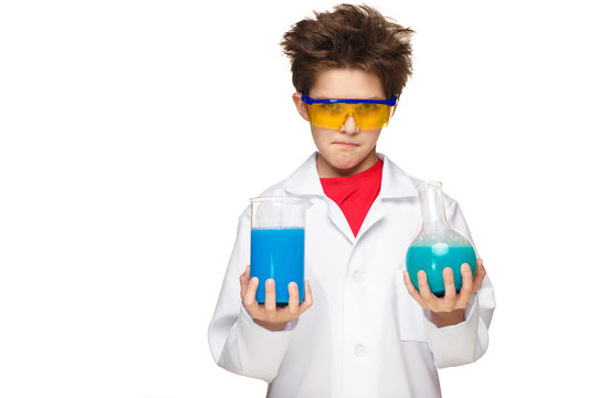 Little boy as chemist doing experiment with chemical fluid in