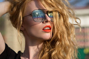 beautiful fashion model with red hair wearing glasses