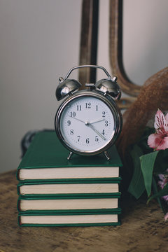 Clock with books and flowers